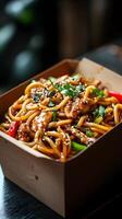 Street-style udon noodles in a takeaway box with toppings photo