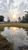 Tranquil Sunrise Reflection in Rural Pond photo