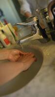 Engaging in the act of washing hands at a sink that has flowing water is essential video