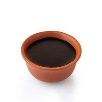 A ceramic bowl of black liquid on a white background photo