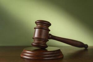 Judge gavel on a green background photo