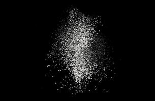 Flour texture on a black background. Flour, dust, snow falling down photo