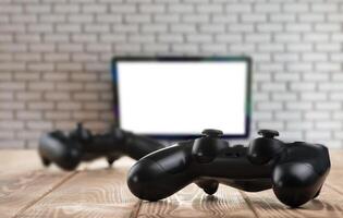 Gamepads on the table with the TV on the background photo