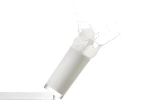 Falling glass with milk on a white background photo