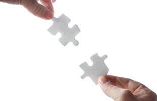 Empty puzzles in hands on a white background photo