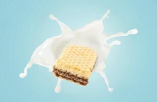 A piece of chocolate biscuit is being splashed with milk photo