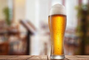Glass of wheat beer on a table in a restaurant photo