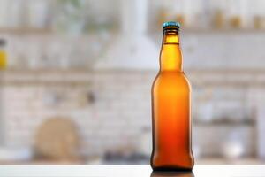 A beer bottle sitting on a table in front of a kitchen photo