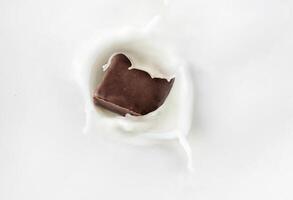 Chocolate candy drops in milk photo