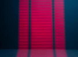 Red Light passing through the blinds and falling on the wall photo
