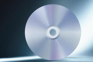 Compact disc on abstract blue background photo