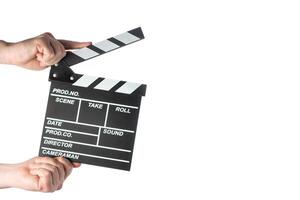 Movie clapperboard in hands on white isolated background photo
