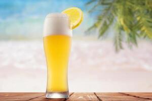 A beer glass with a lemon slice on the table photo