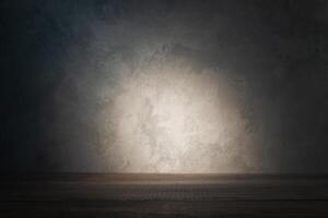 Table top on background of concrete wall with ray of light photo