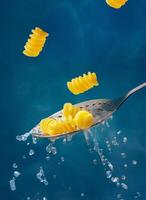 Pasta and colander on a blue background photo
