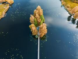 Autumn landscape with a fisherman's house on a small island in the river photo