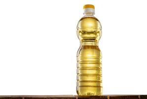 Bottle of sunflower oil on the table with isolated background photo