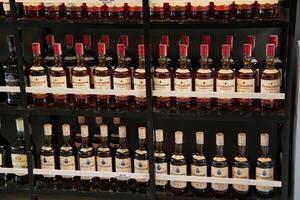 a shelf full of bottles of alcohol photo