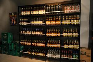 a shelf with bottles of filipino alcohol photo