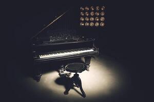 A piano in the dark with a light shining on it photo