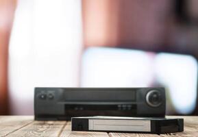 A dvd player and a remote control sitting on a table photo