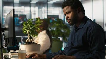 Employee in office leaving desk to present revenue figures on tablet. Accountant finishing project task of comparing company statistical numbers on device, going to present data, camera A video