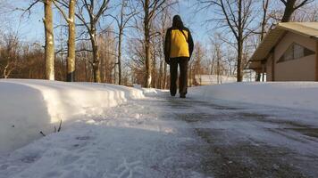 person walking down snow covered path video