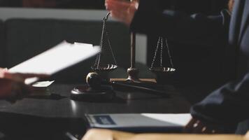A judge is holding a gavel and a paper with a scale video
