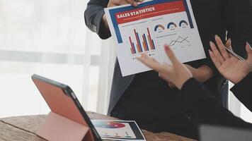 Business people looking at a chart on a laptop video