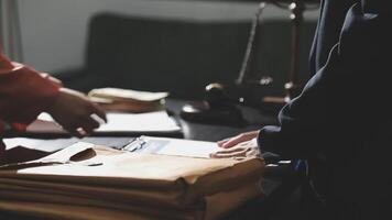 Two people are standing over a desk with papers video