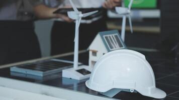 A hard hat and a solar panel on a table video