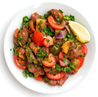 A vibrant dish of seasoned meat and vegetables with a side of lime. png