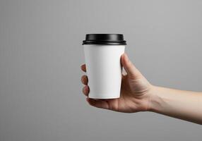 Hand Holding a Blank White Paper Cup for Logo Design Mockup 1 photo
