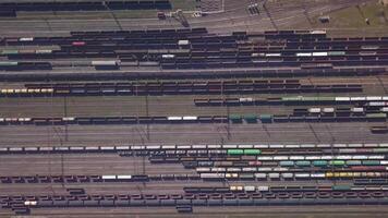 Aerial view of Railway sorting station and A lot of wagons at a railway. Drone flies over railway tracks. 4k quality video