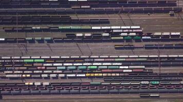 Aerial view of Railway sorting station and A lot of wagons at a railway. Drone flies over railway tracks. 4k quality video