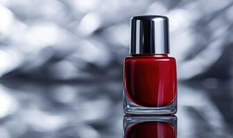 a red nail polish bottle on a shiny surface photo