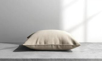 A white pillow sits on a table in front of a window photo