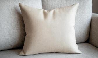 A pillow with a pattern of lines sits on a couch photo
