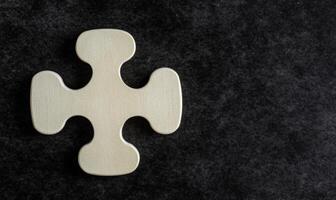 Solo Wooden Puzzle Piece on Dark Background, Symbolizing Individuality and Uniqueness in Design or Play, Inspirational Image for Creative Projects photo