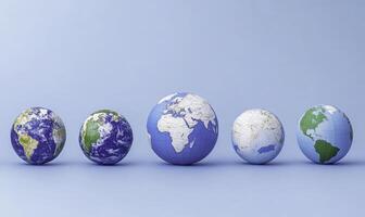 Five different colored eggs with the earth on them photo