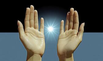 Two hands with a light shining in between them photo