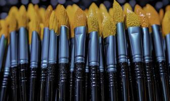 A bunch of brushes with yellow and black tips photo