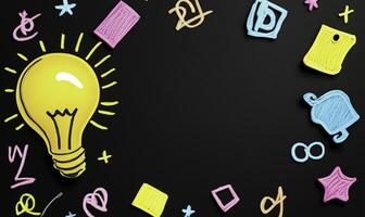A light bulb surrounded by various items on a black background photo