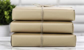 Three wrapped brown boxes on a marble counter photo