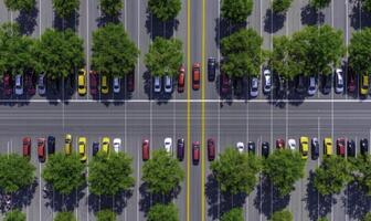 Aerial View of Urban Parking Lot Featuring Colorful Cars and Lush Green Trees Between Parking Spaces in a Busy City Setting photo