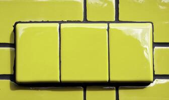 Bright Yellow Tiles on a Wall, Glossy Finish, Simple and Modern Design, Perfect for Home Decoration and Renovation Projects, Vibrant Color Contrast photo