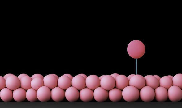 Pink spheres arranged in a row with a single distinguishable sphere on a stick showcasing uniqueness against a black background photo