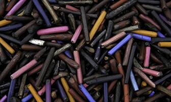 Colorful Art Materials in Various Shades and Textures, Close-Up View of Discarded Crayon Residues and Broken Pieces on a Surface photo