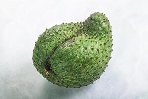 A green fruit on a white background photo