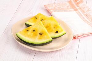 A white plate with slices of watermelon photo